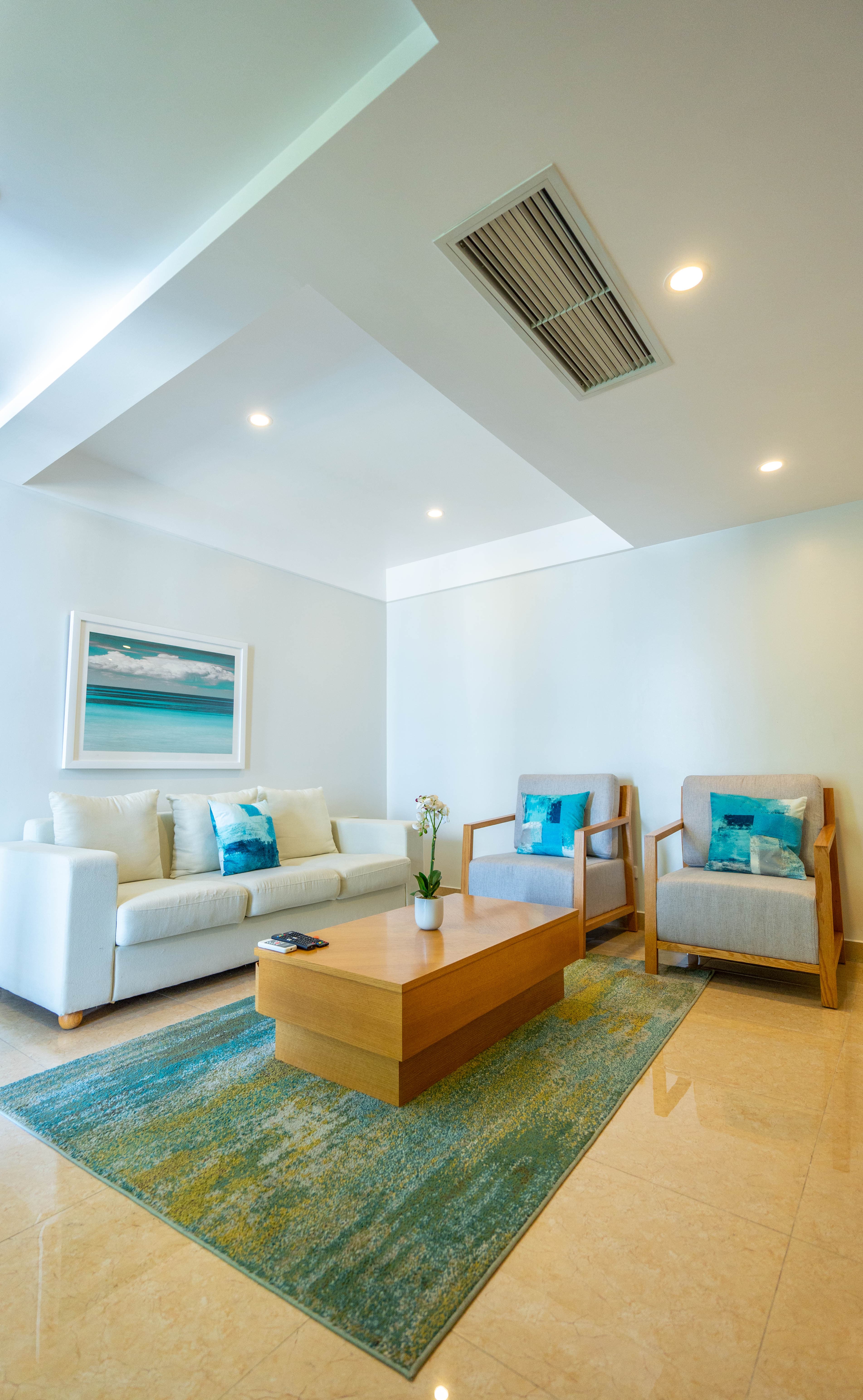 Sitting area with sofa and two coordinating armchairs and a wooden coffee table