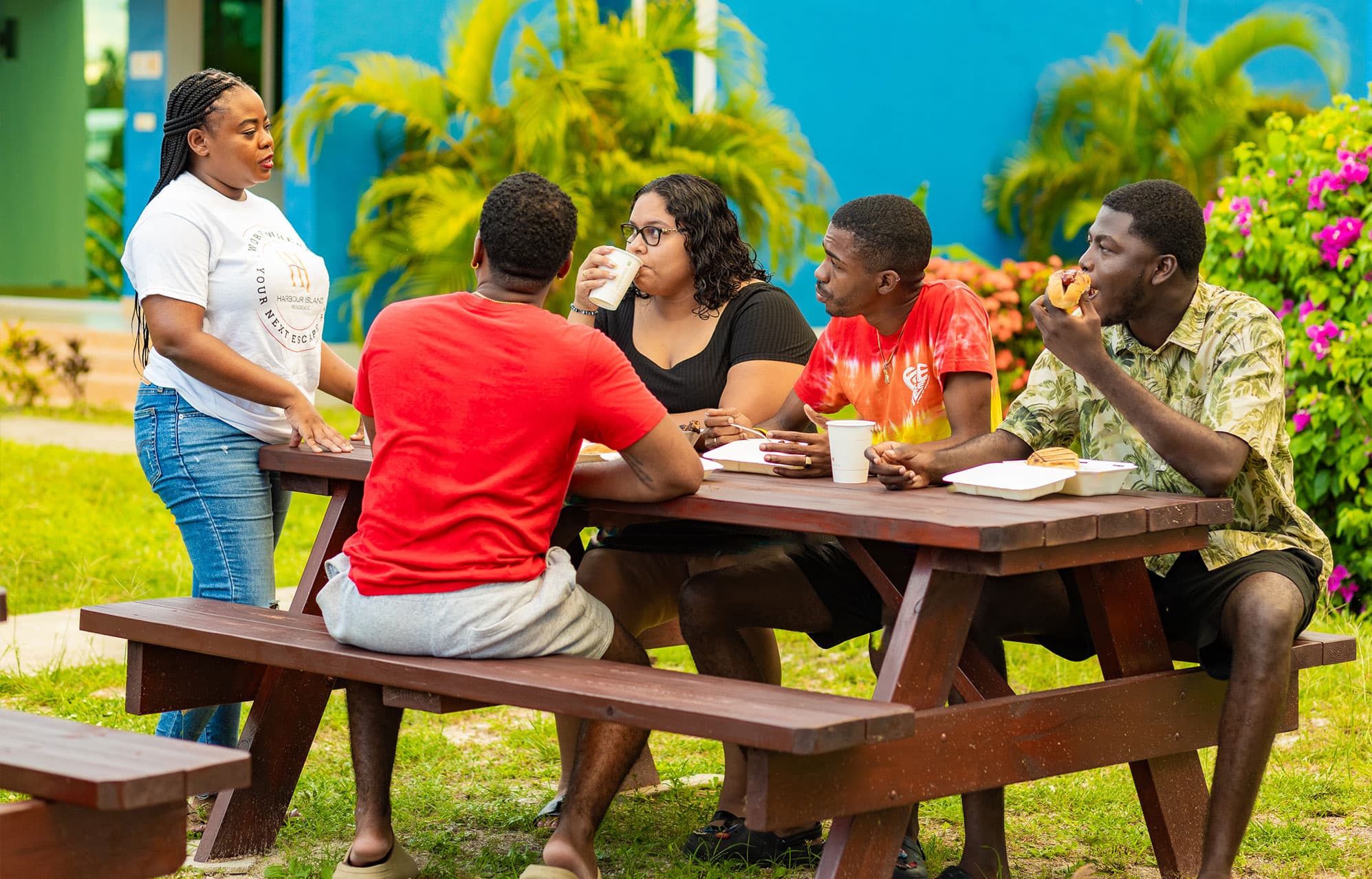 Group of young people and staff member sitting at picnic table at Harbour Island Residences