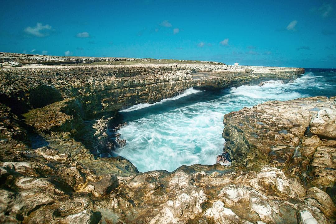 Devil's Bridge, a famous natural landmark in Antigua and Barbuda, showcasing the rugged coastline and powerful ocean waves.